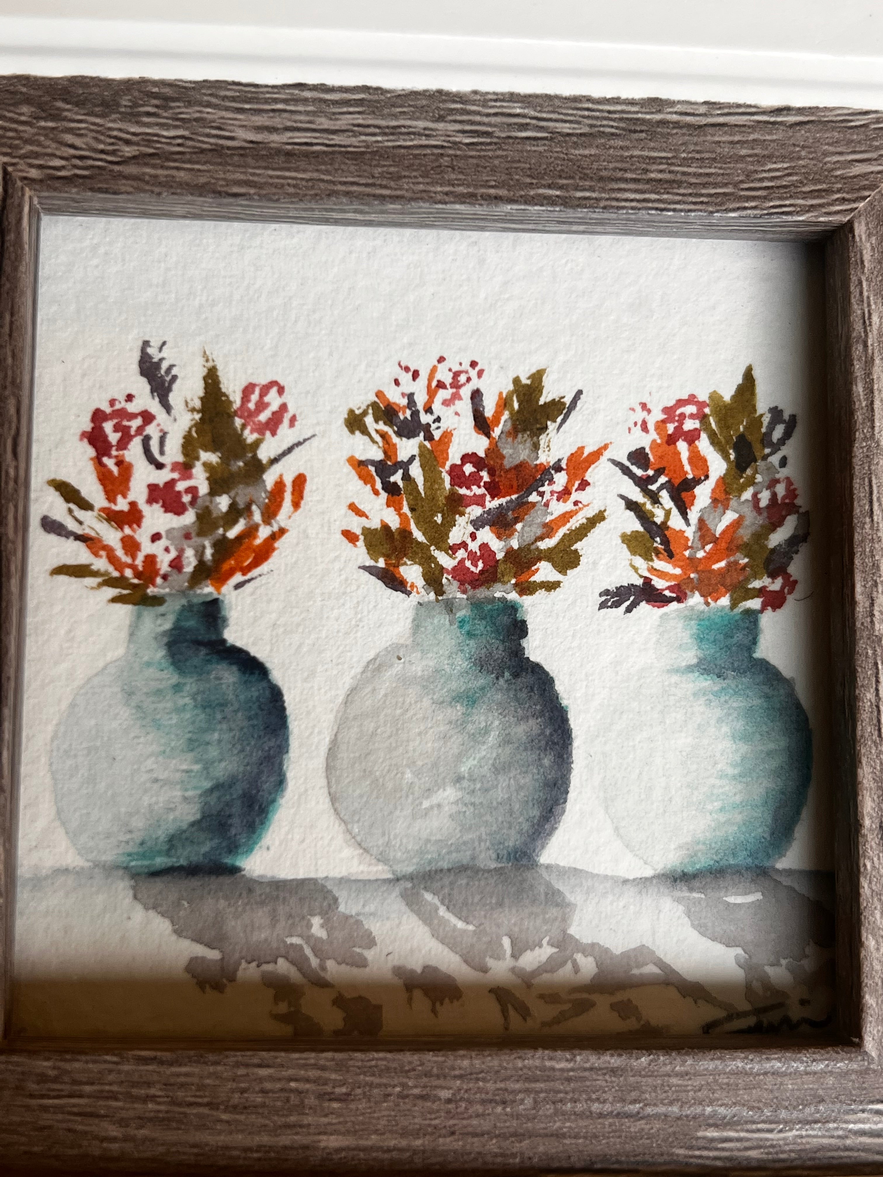 Framed watercolor painting with abstract floral and circular designs.